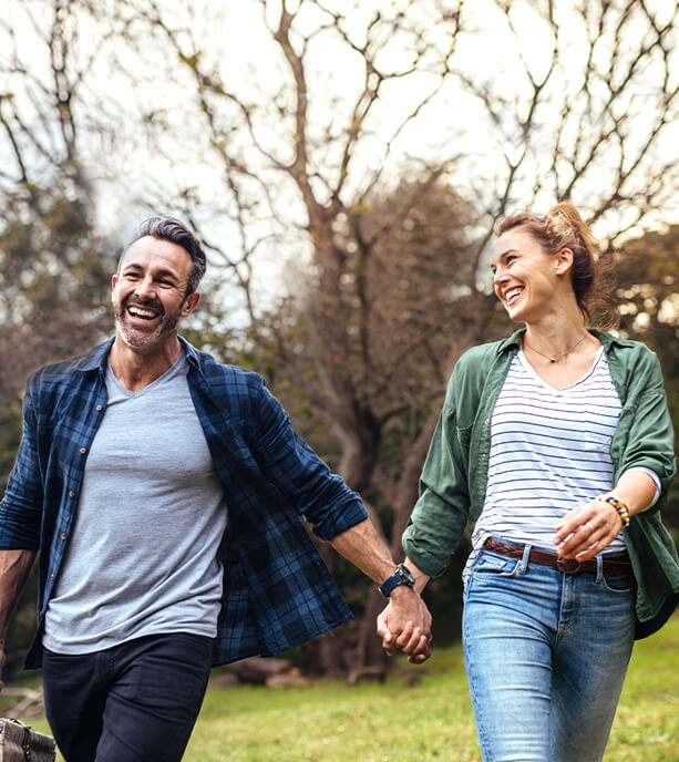 A mother holding her daughter while both are laughing